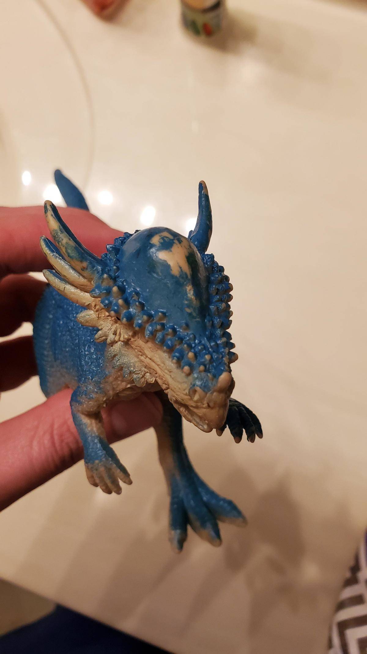 Toy dinosaur with a worn-down forehead from being played with a lot