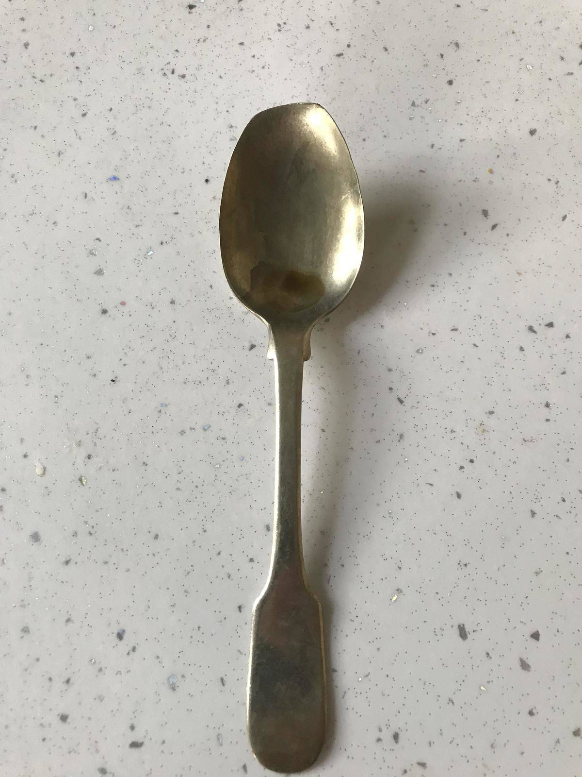 Spoon with worn-down tip from hitting bottom of cups