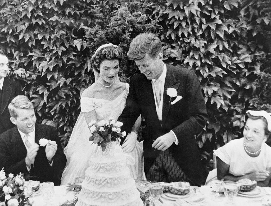 John F. Kennedy and Jacqueline Bouvier cutting their wedding cake