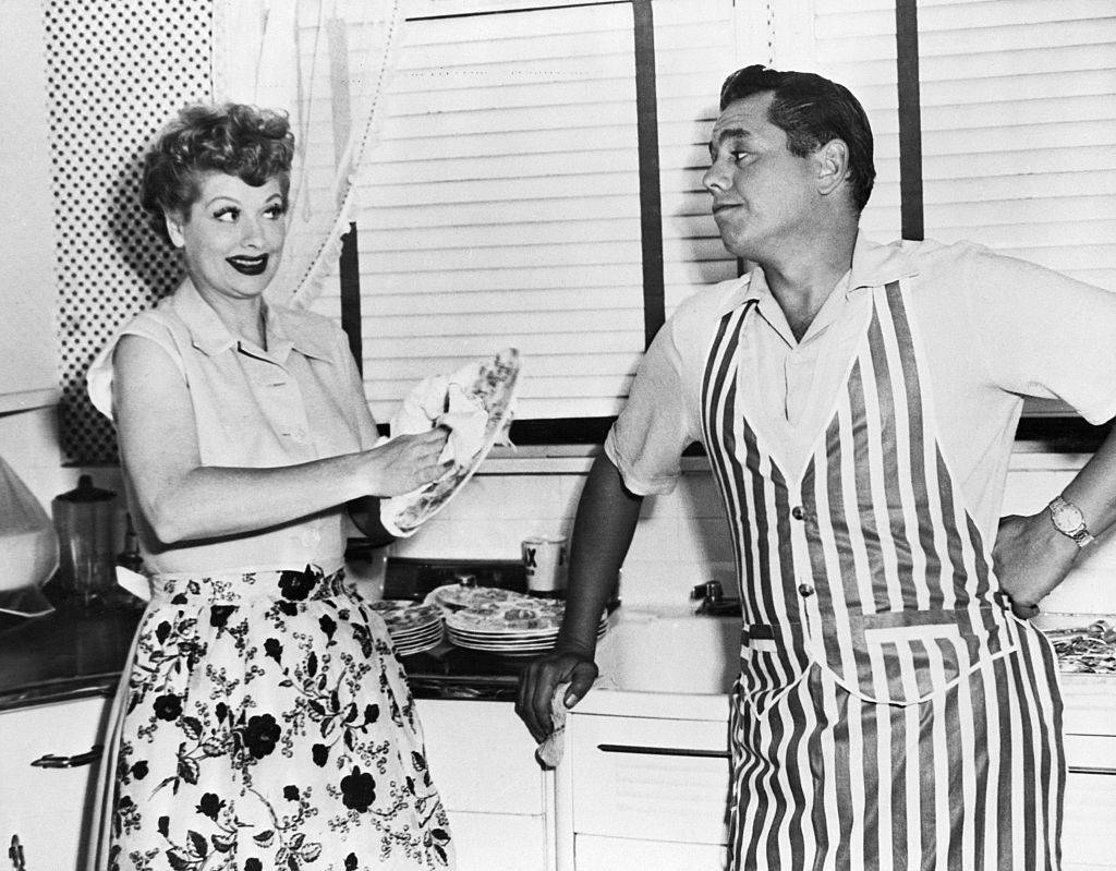 Lucille Ball and Desi Arnaz washing dishes at home on their five acre ranch.