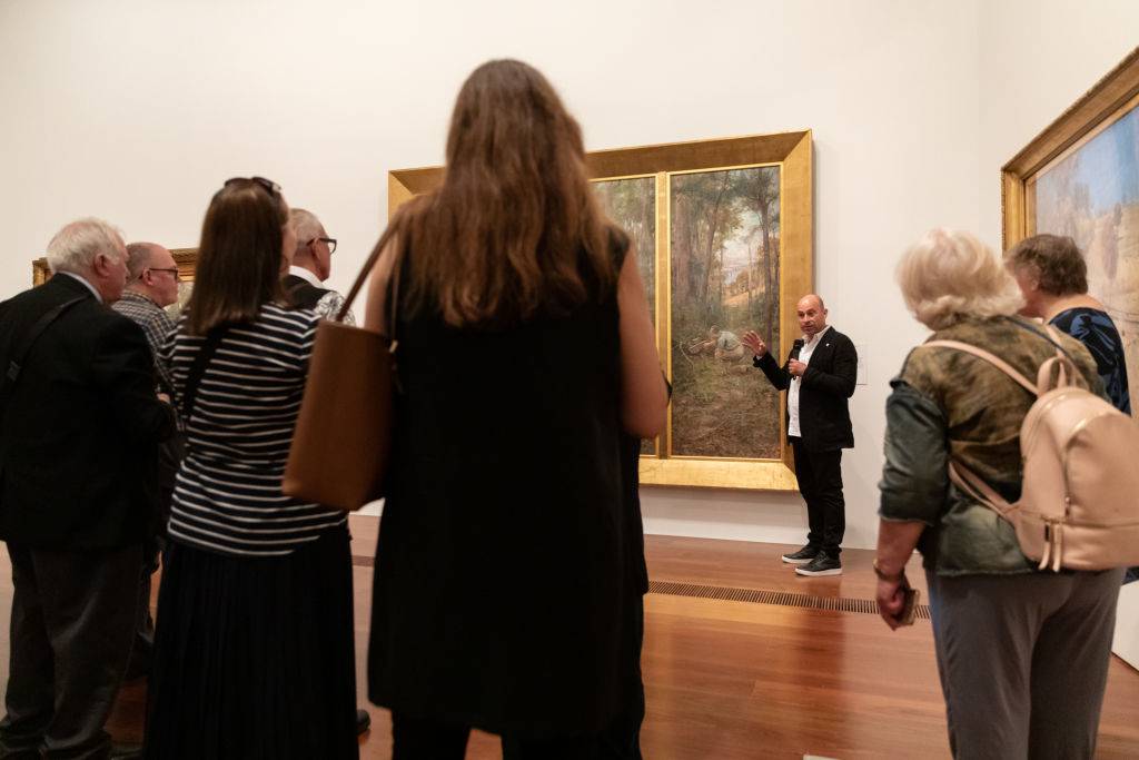 michael varcoe-cocks speaking at a museum with the pioneer
