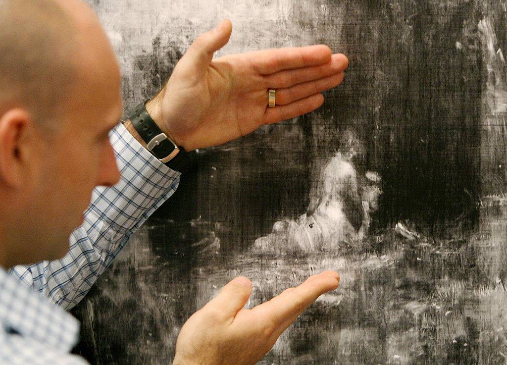 Michael Varcoe-Cocks points out x-ray in painting