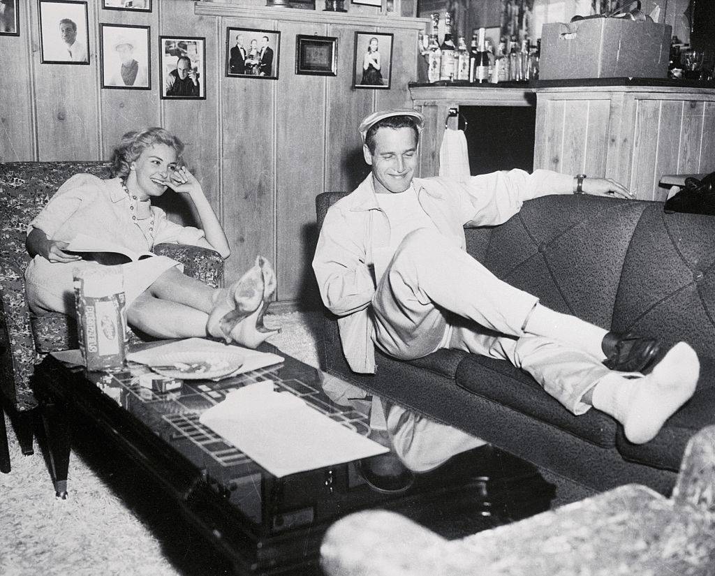 Feet up, Joanne and Paul Newman share a relaxing moment while reading movie scripts