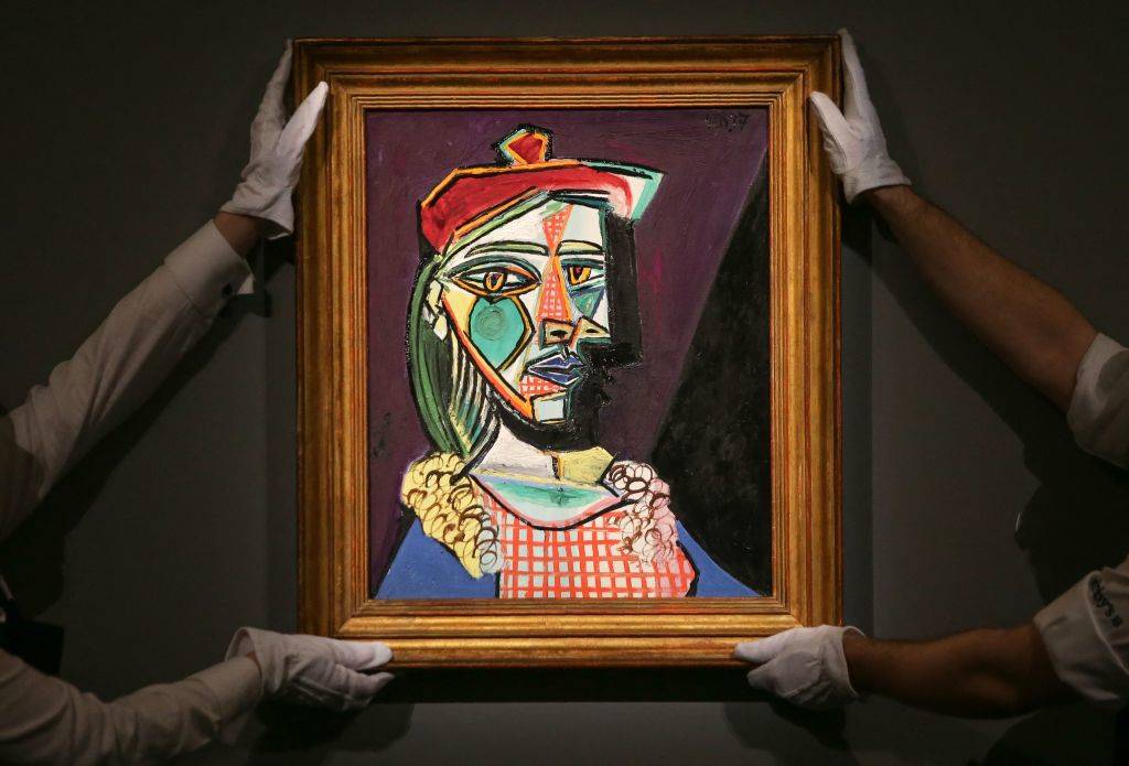 a picasso painting being held up