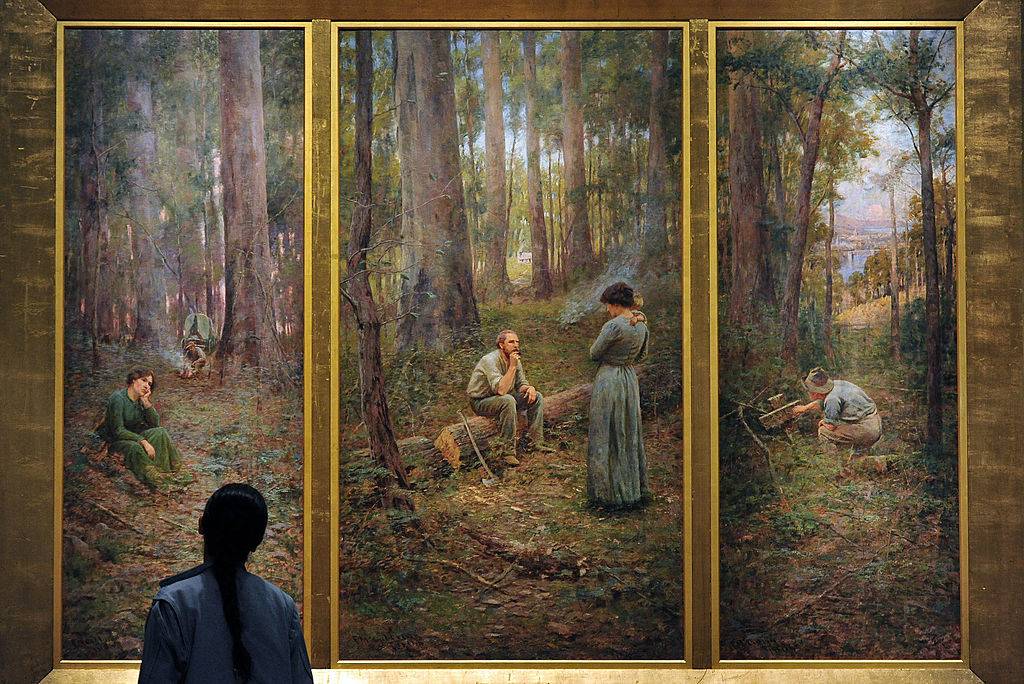 A visitor views a painting by Australian artist Frederick McCubbin entitled 'The Pioneer'