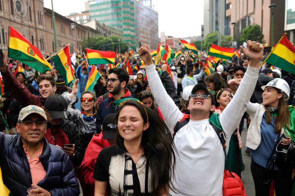 people holding flags in bolivia