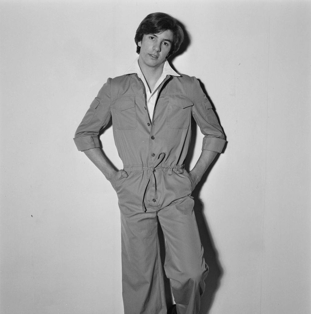 A male model wearing a safari suit with a drawstring waist