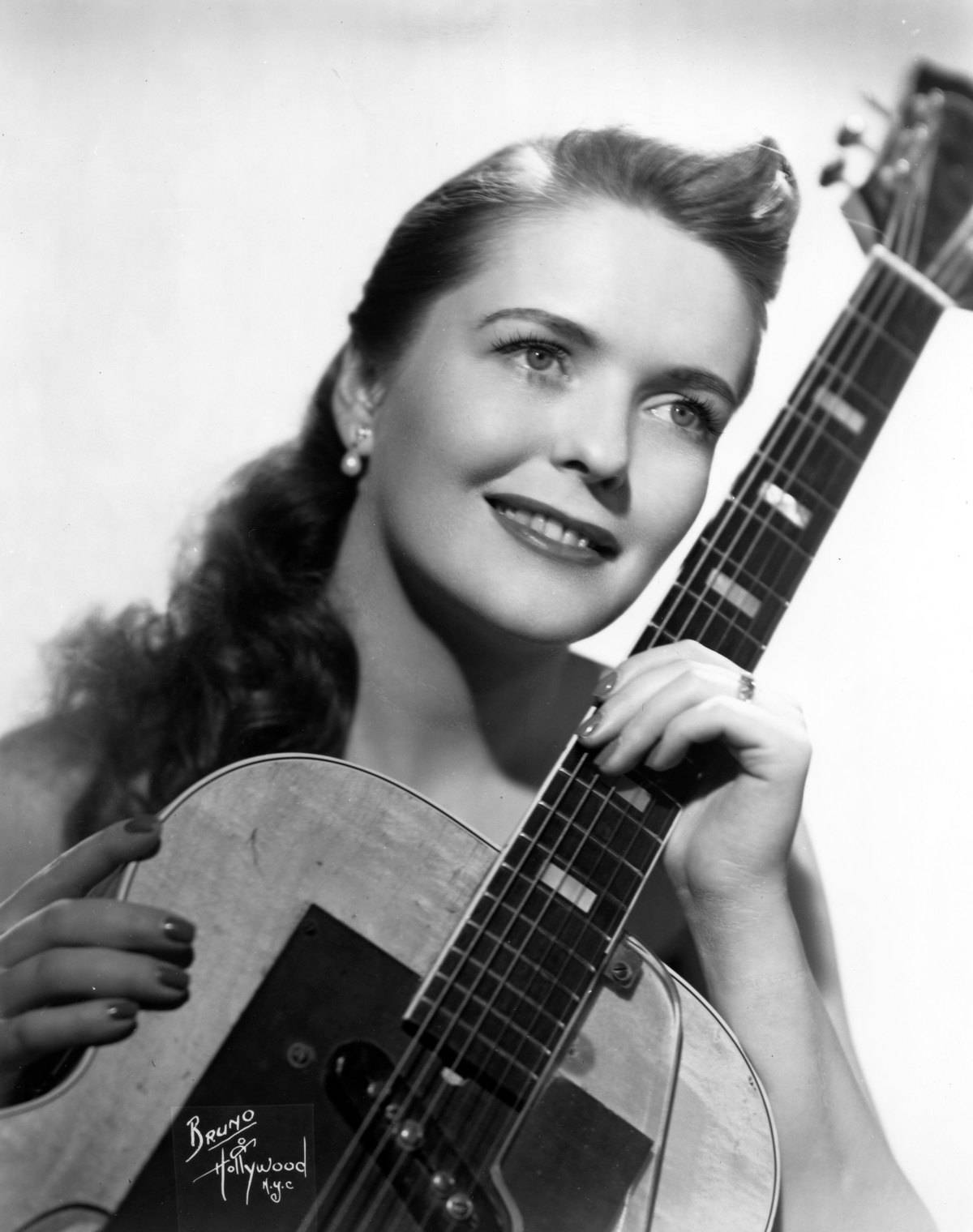 Mary Ford Holding A Guitar