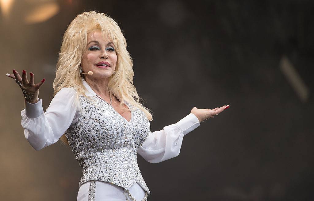 Dolly Parton on stage in a white outfit