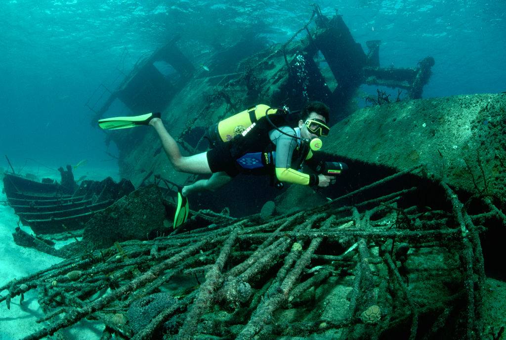 divers explore a wreck