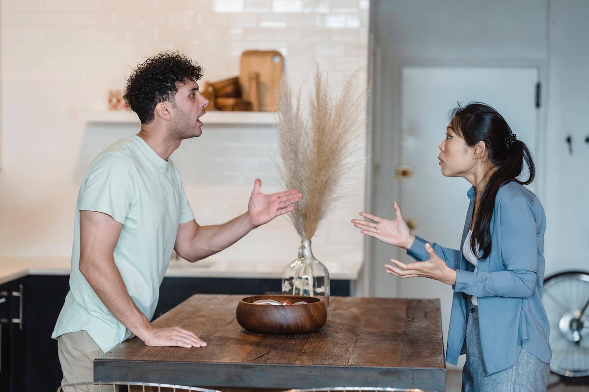 Man talking angrily with arm outstretched 