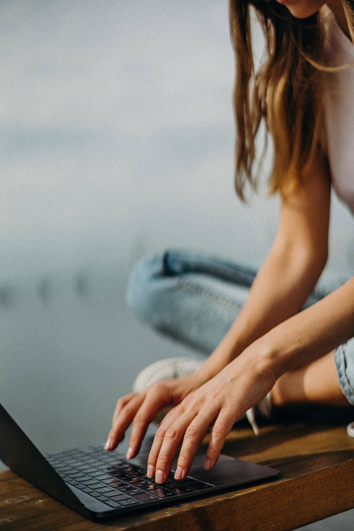 Woman's hands typing on laptop keyboard 