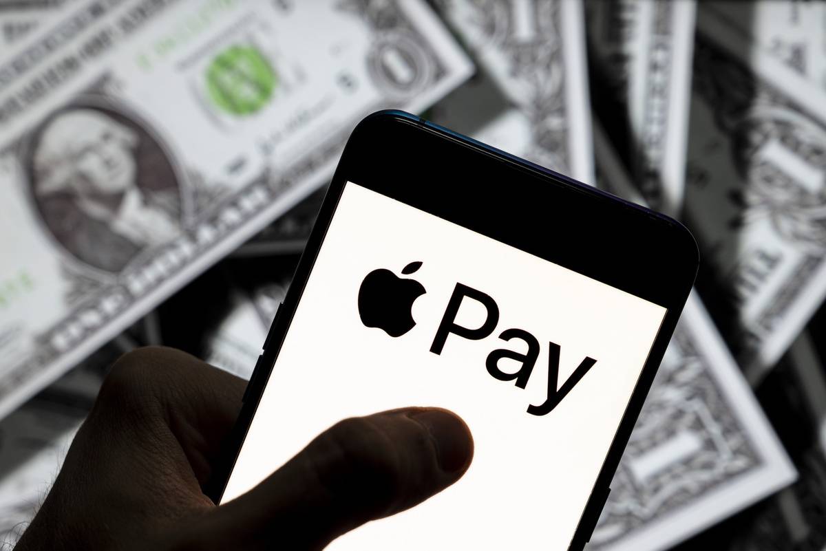 Photo illustration of the mobile payment and digital wallet service by Apple, Apple Pay, logo seen displayed on a smartphone with USD (United States dollar) currency in the background.