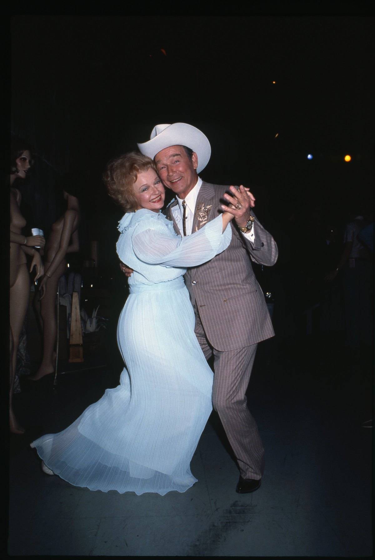 Roy Rogers dances with Dale Evans who is wearing a powder blue floor-length dress