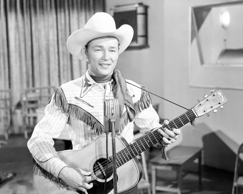 Roy Rogers holds acoustic guitar