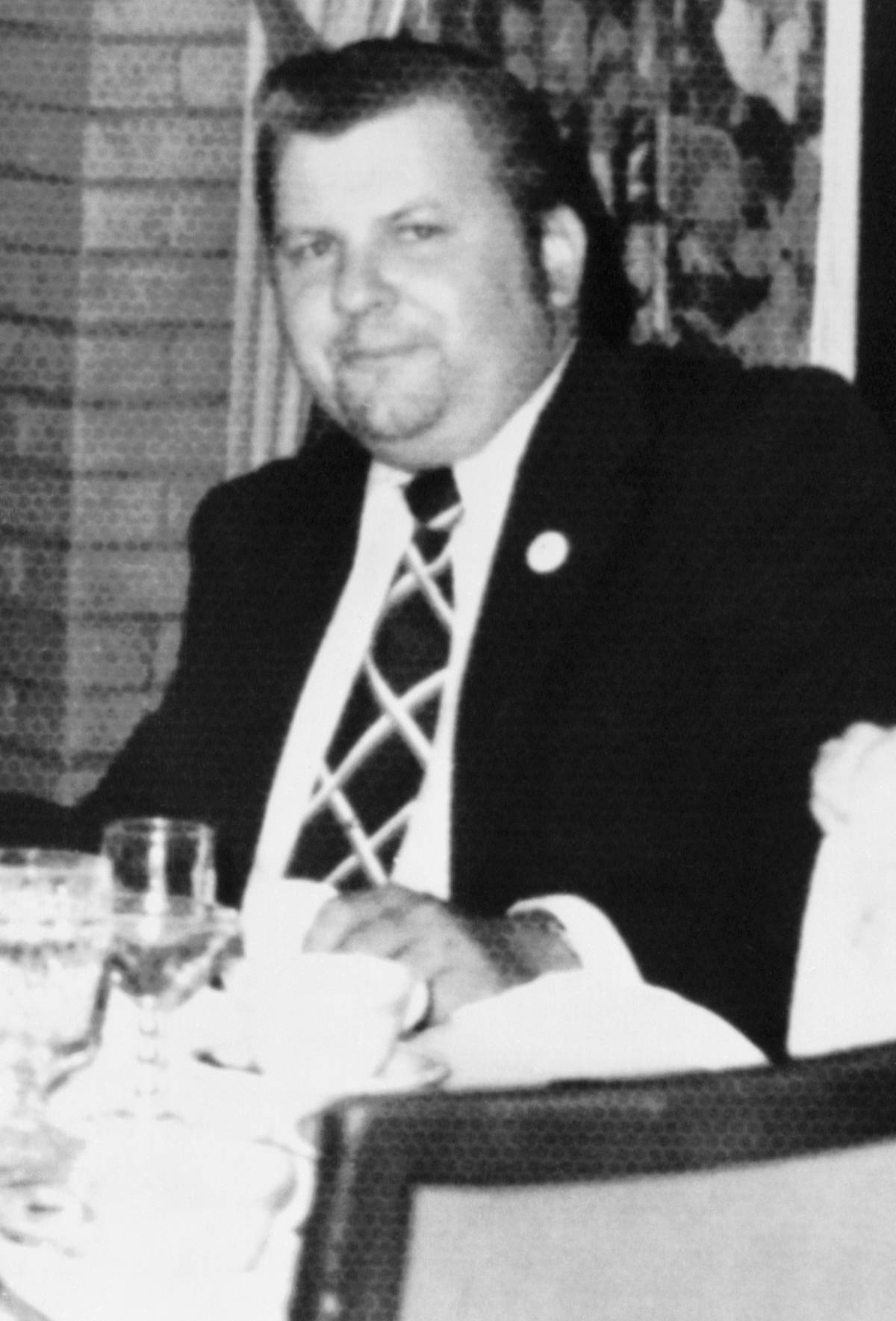 Serial Killer John Wayne Gacy Seated at Table