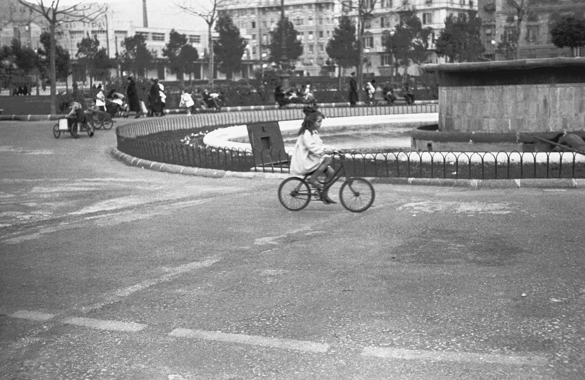 Little girl on bicycle, children playing, Genoa