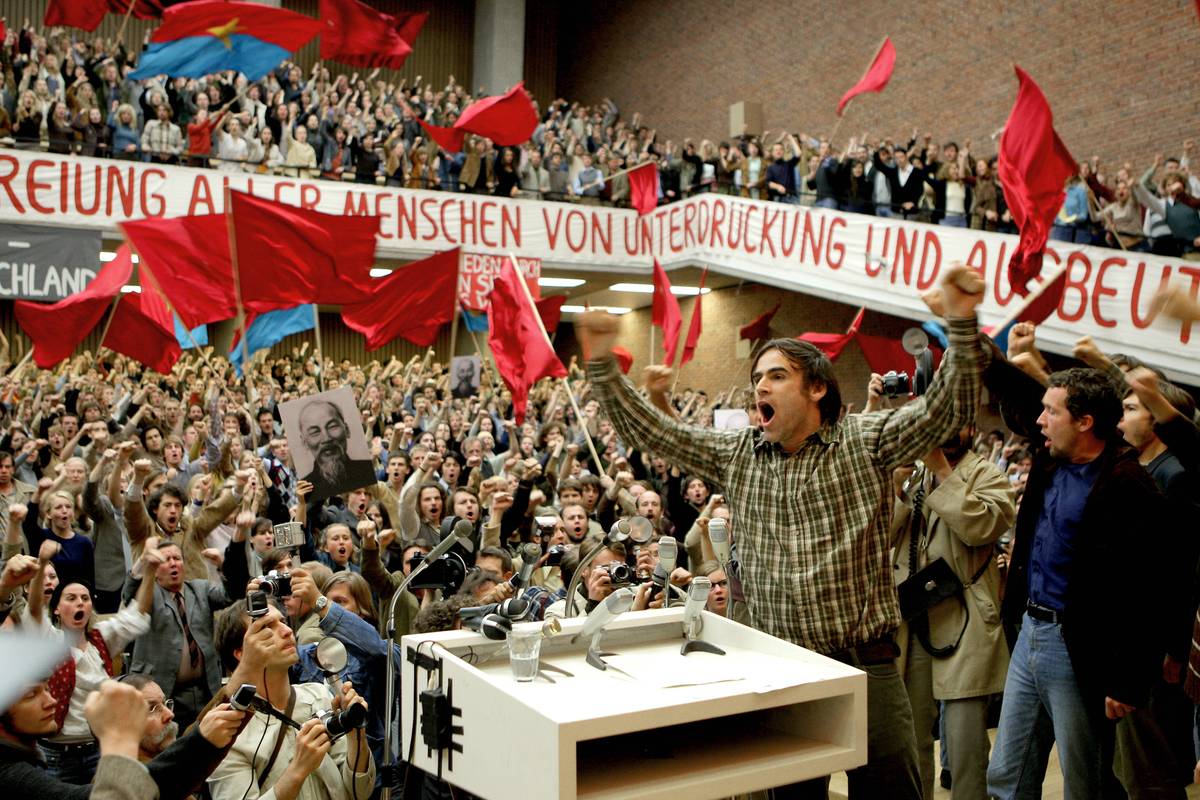 Man screaming amid crowd of Marxists waving red flags in The Baader-Meinhoff Complex