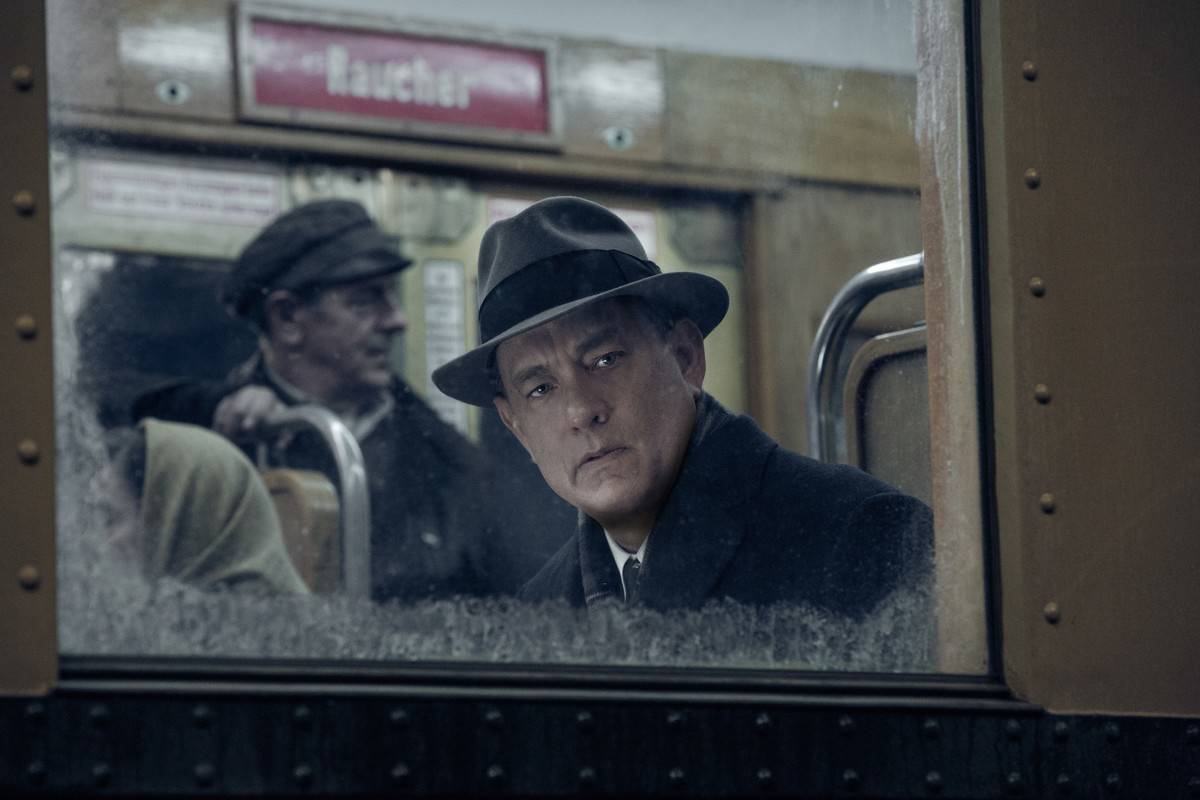 Tom Hanks as James Donovan looking out the window of train in Bridge of Spies