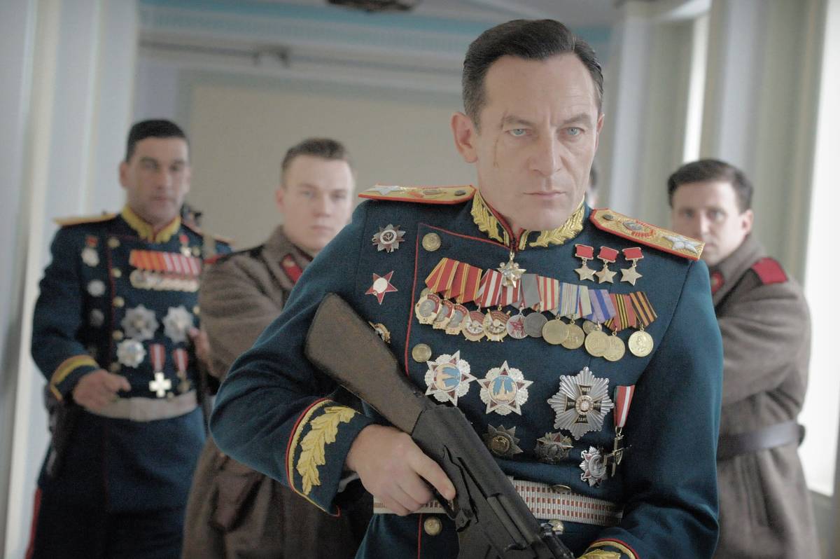 Jason Isaacs holding Kalashnikov rifle as Field Marshall Zhukov in The Death of Stalin