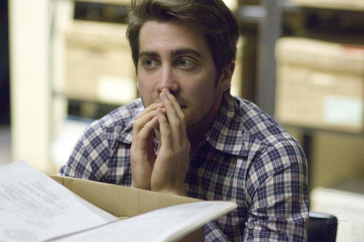 Jake Gyllenhaal looking nervous while covering his face in Zodiac