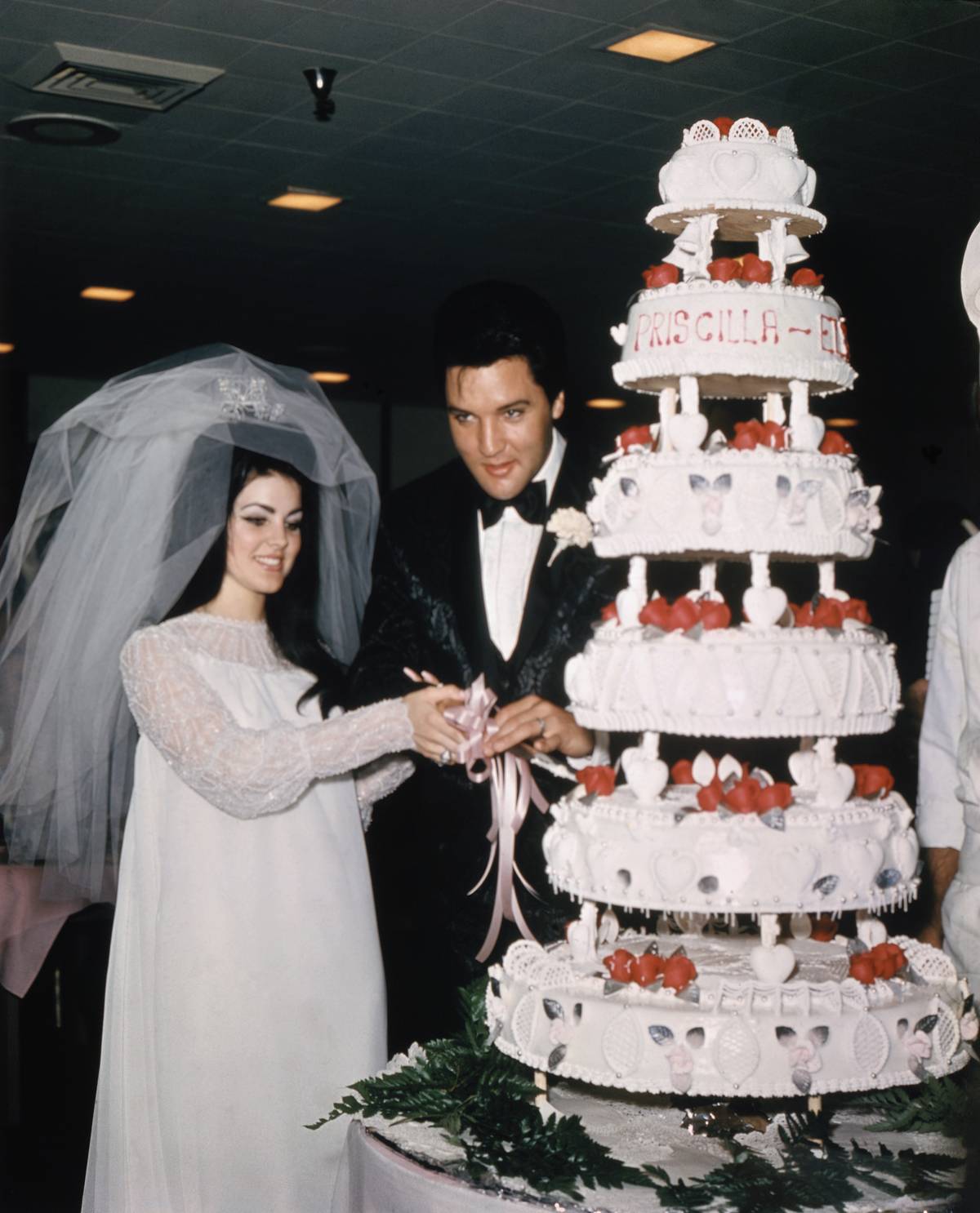 Elvis and Priscilla Presley Cutting Wedding Cake