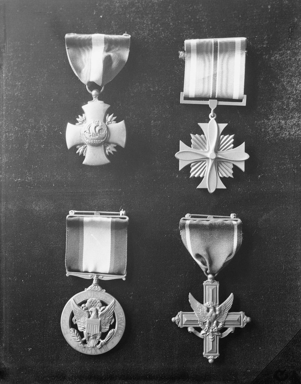 Philadelphia, Pennsylvania: Above are four of the medals awarded to our  soldiers and sailors for distinguished service, which means gallantry in
 the service of their country. The medals are made at the Philadelphia 
Mint, where all the master and working dies are struck. Top left is the 
Navy Cross; top right, Distinguished Service Flying Cross for Army and 
Navy. Bottom left, Army Distinguished Service Medal; Right, Army 
Distinguished Service Cross.