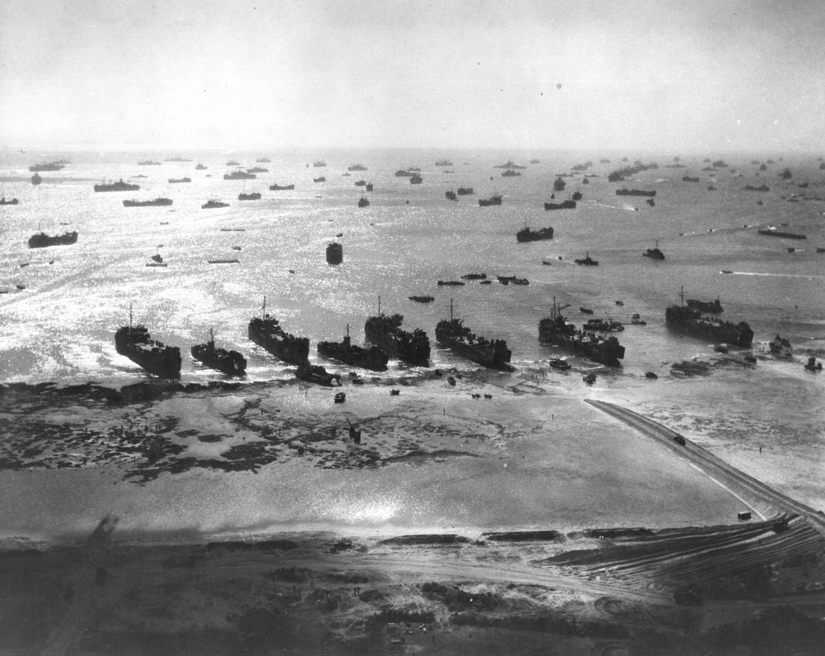 American warships protect troops during a World War II beach landing, Okinawa, Japan, 1945.