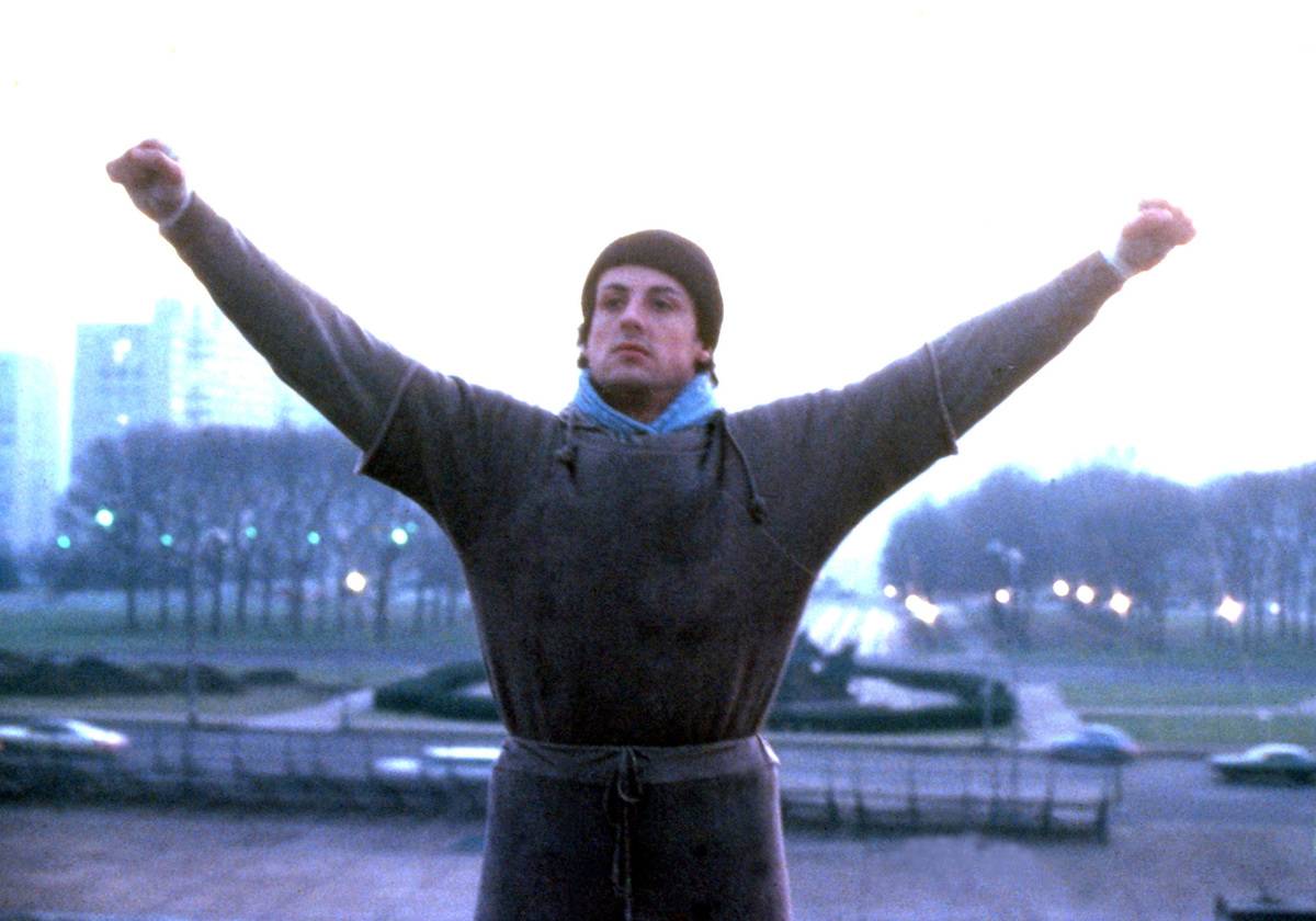 man raising his arms