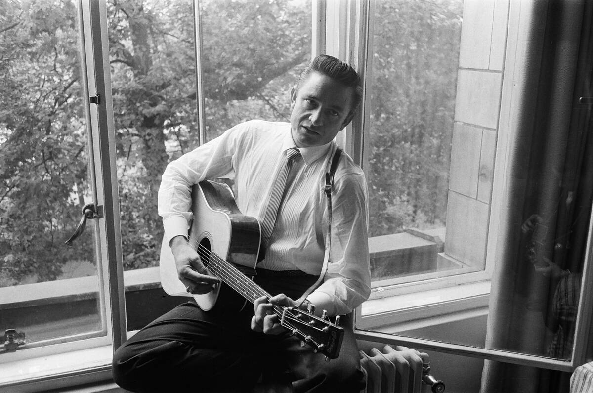 American country singer and musician Johnny Cash poses for photographers at the Savoy Hotel in London. 17th September 19