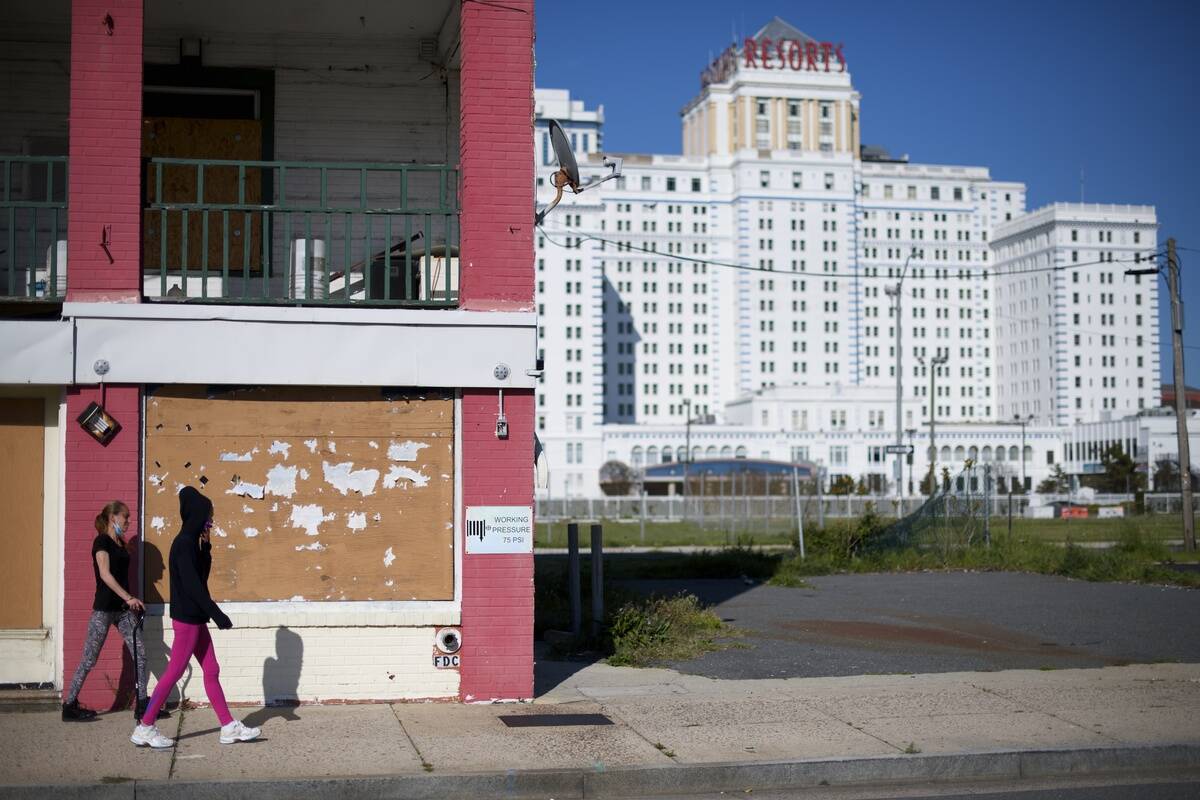 Women walk past a building in disrepair across the street from Resorts Casino on May 7, 2020 in Atlantic City, New Jersey.