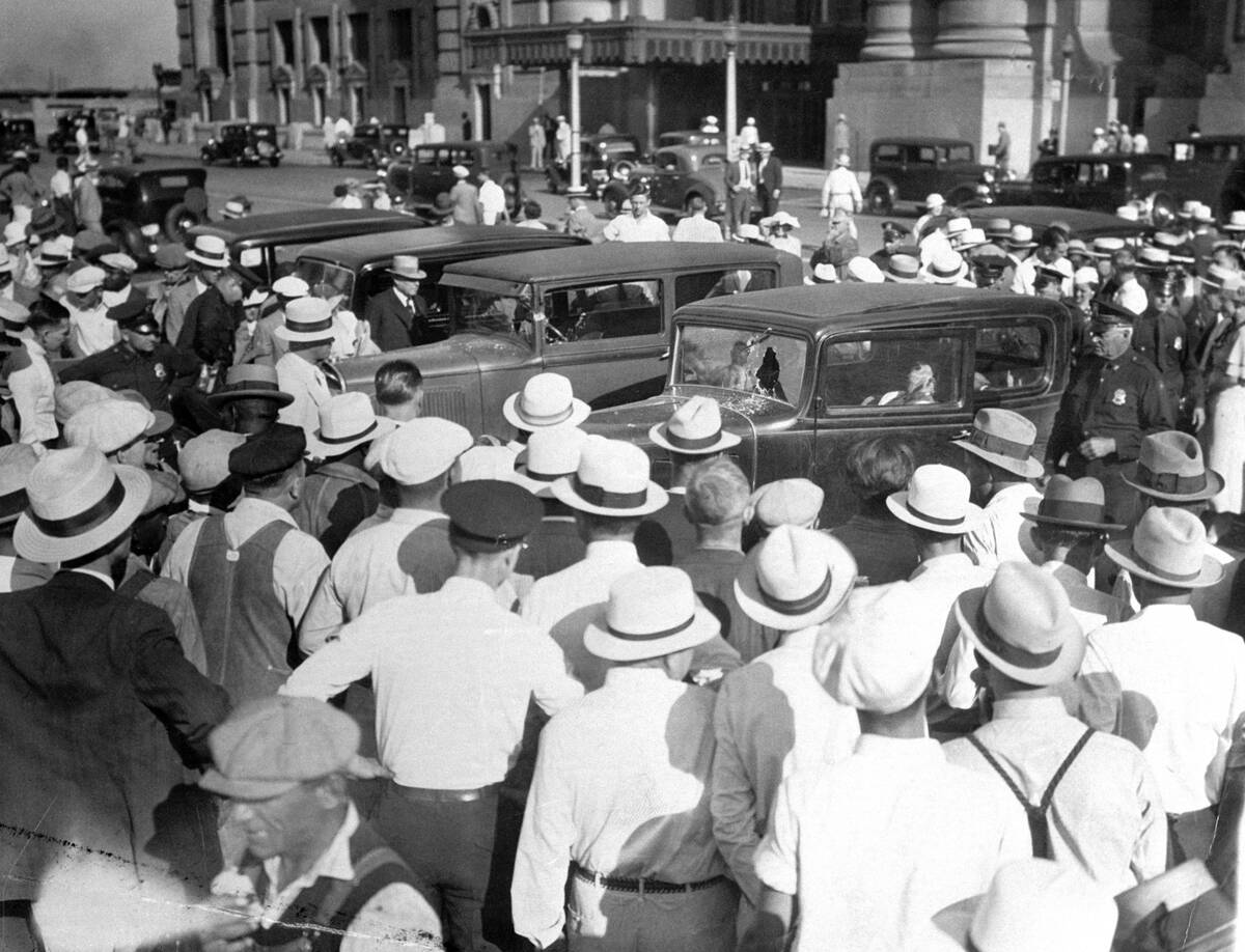 A crowd gathers around the autos where gangsters killed four officers and a gunman at the Union Station Plaza, Kansas City.