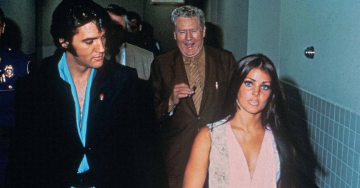 Elvis and Priscilla Presley walking in a room
