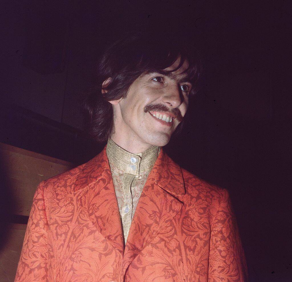 george harrison with a red jacket in 1967