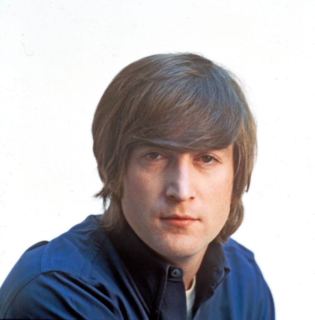 john lennon posing for a photo in 1966