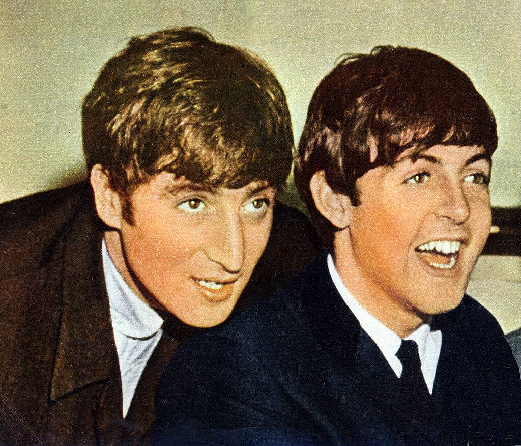 John Lennon and Paul McCartney posing for a photo in 1963