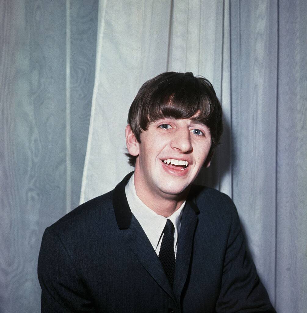 ringo starr posing for a photo in 1964