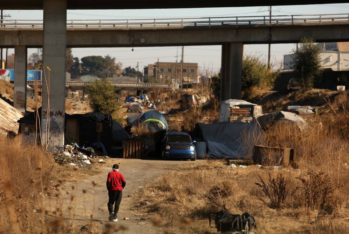 A man makes his way to a homeless encampment in Stockton on December 10, 2020.