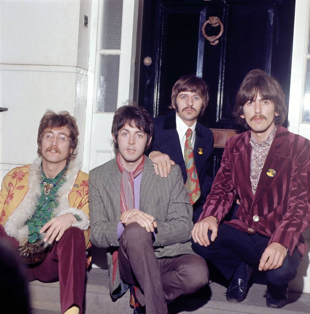 the beatles posing for a photo in 1967