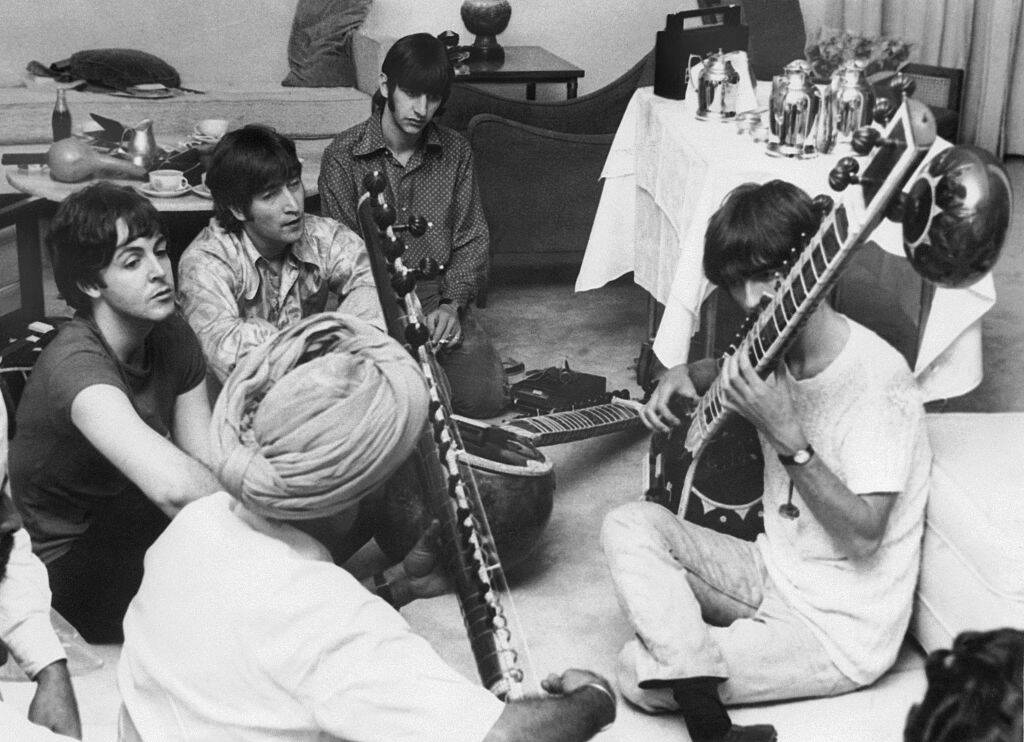 George Harrison receiving instruction in playing the sitar