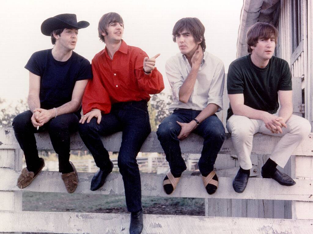 the beatles posing for a photo in 1965