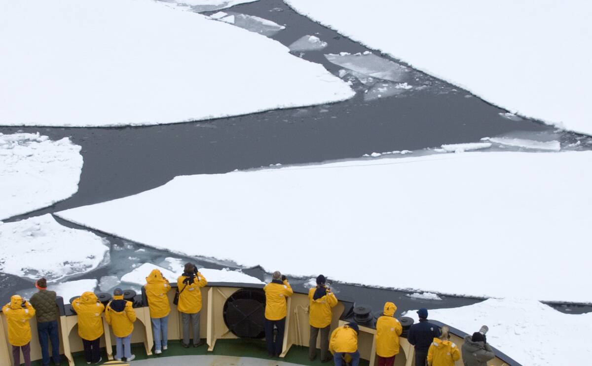 Tourists on Ice breaker, the Kapitan Khlebnikov, breaking through broken pack ice, Weddell Sea, Antarctica