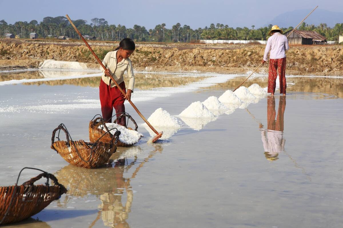 A young girl and her mother extracting salt.