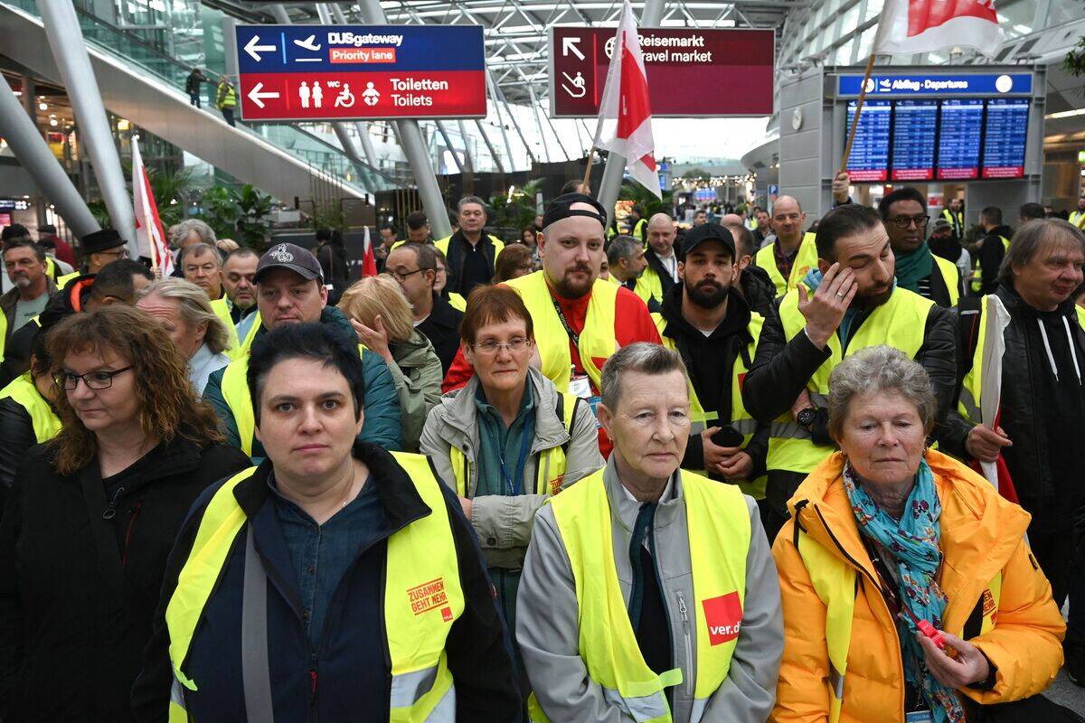 Aviation security staff organized in the public transport sector union  Verdi gather for a demonstration during a strike at the airport of 
Duesseldorf, western Germany, on April 20, 2023.