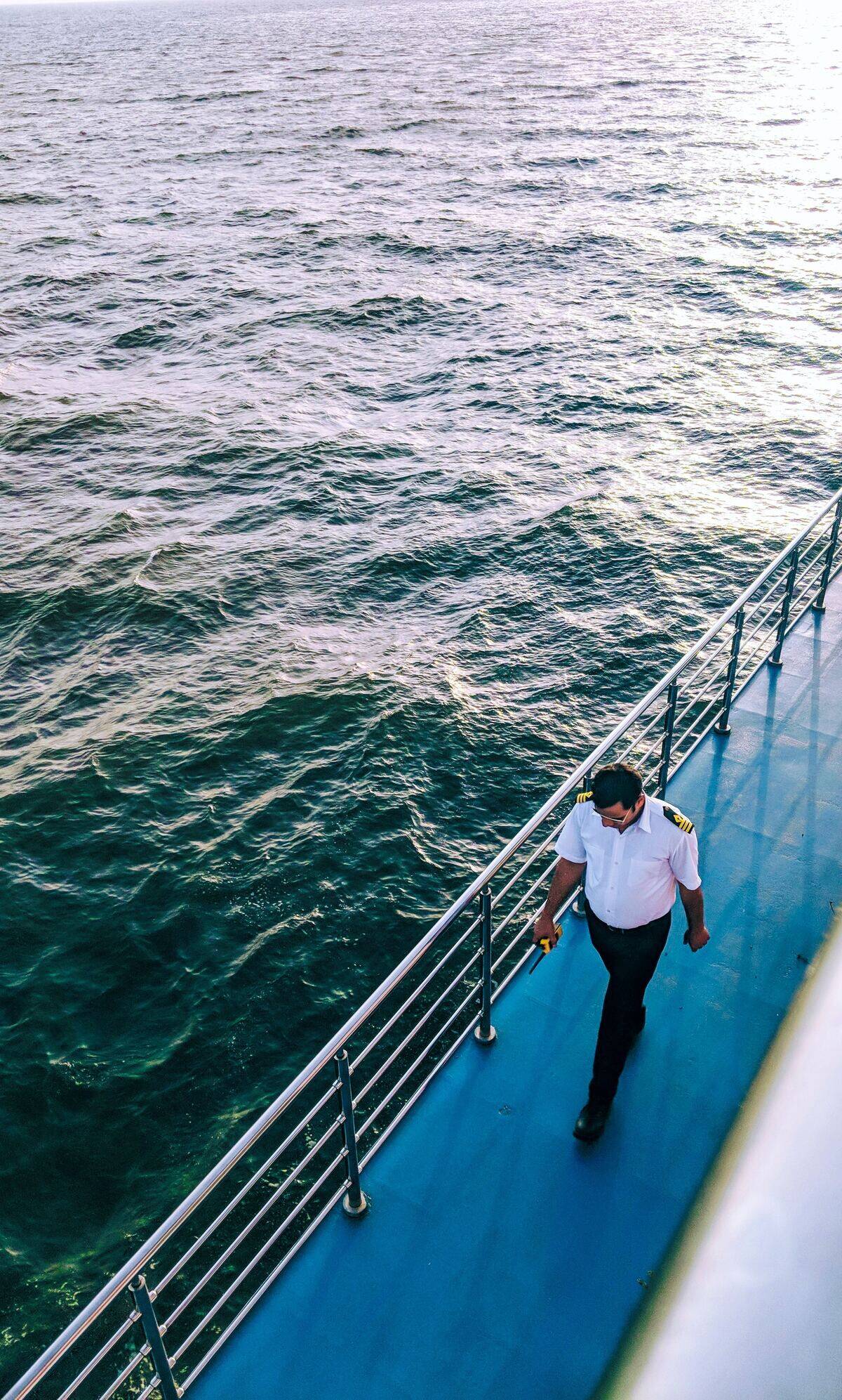 Crew member walking on cruise ship deck