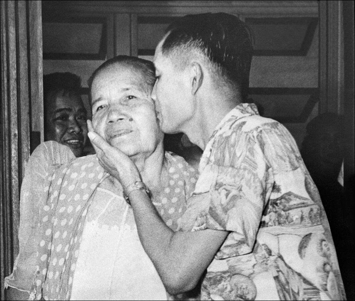 Luis Taruc, rebel leader of the Huks in the Philippines and founder of the communist struggle in the Philippines, kisses his mother who he hadn't seen since six years, at Camp Murphy where he was detained after his surrender to officials 22 May 1954.