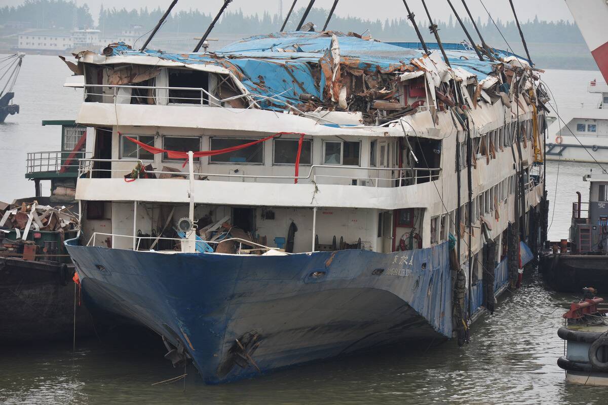 Rescue workers search and clean up rooms in the lifted cruise ship on June 7, 2015 in Jianli, China.