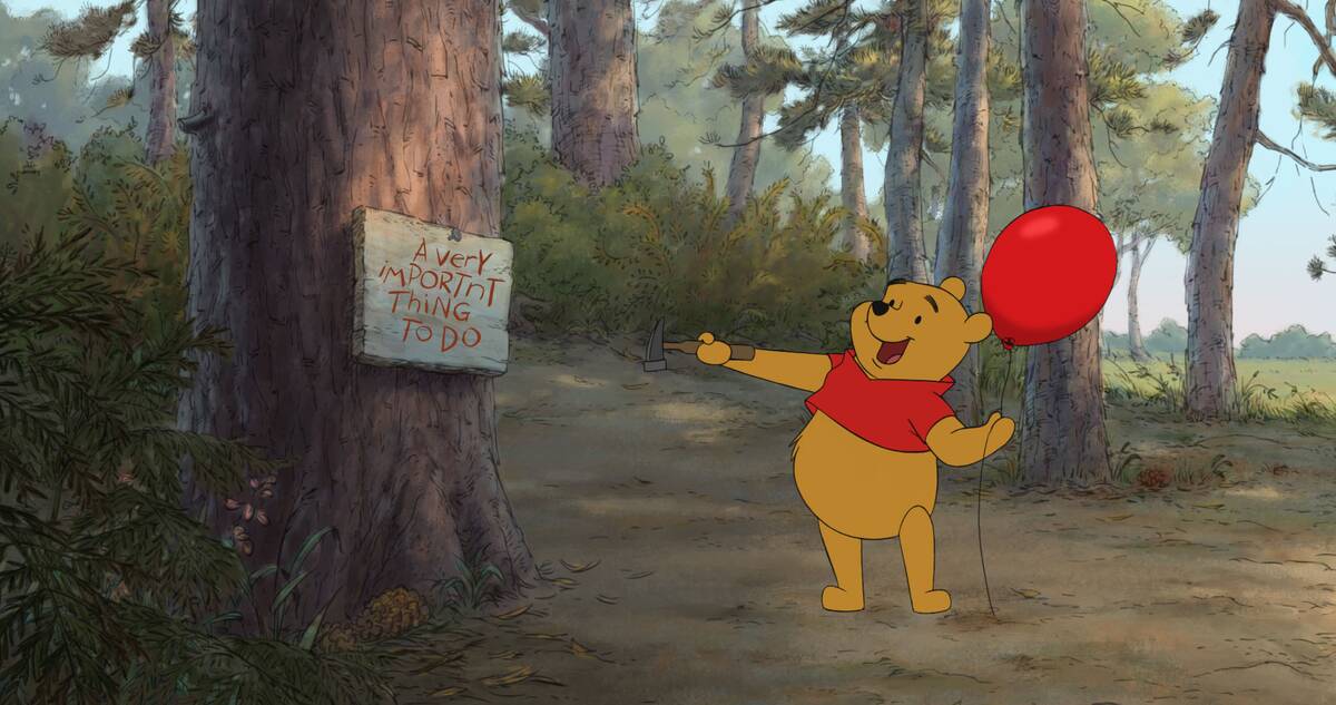 Winnie The Pooh happily pointing to sign while holding red balloon