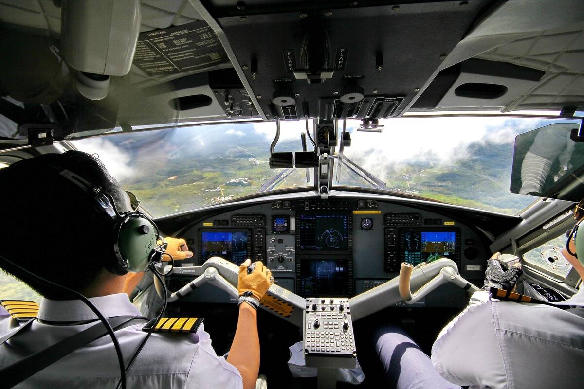 pilots flying aiplane with scenery visible