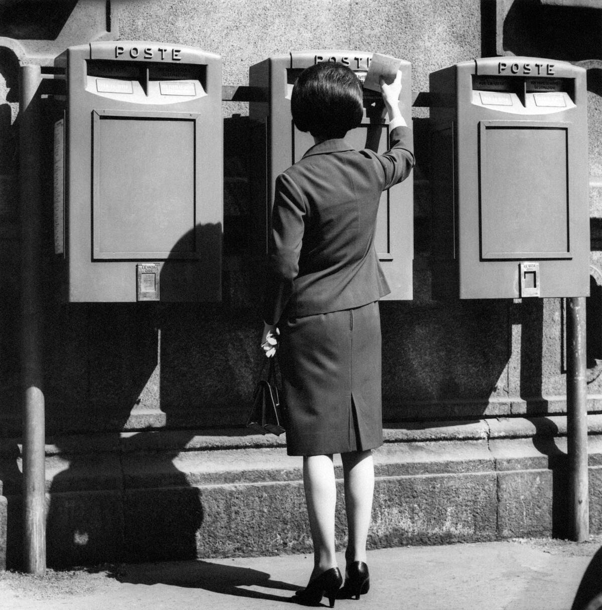 A woman mailing a letter